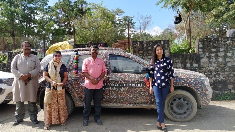 Members of ‘Road Ashram’ with founder of YouthNet, Hekani Jakhalu Kense posing in front of their custom crafted car in Kohima. (Morung Photo)